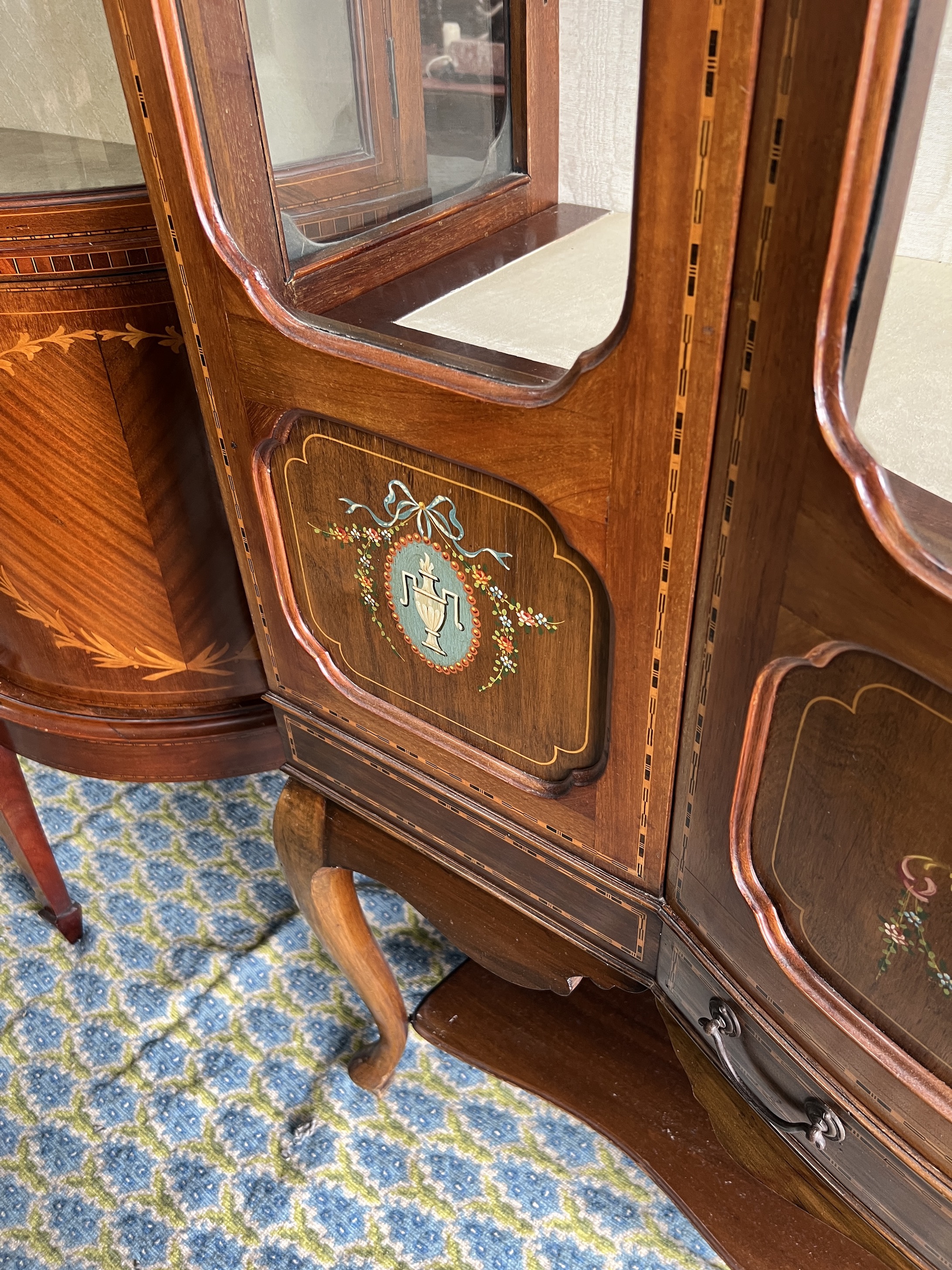 An Edwardian inlaid and painted mahogany bowfront display cabinet, width 136cm, depth 50cm, height 179cm